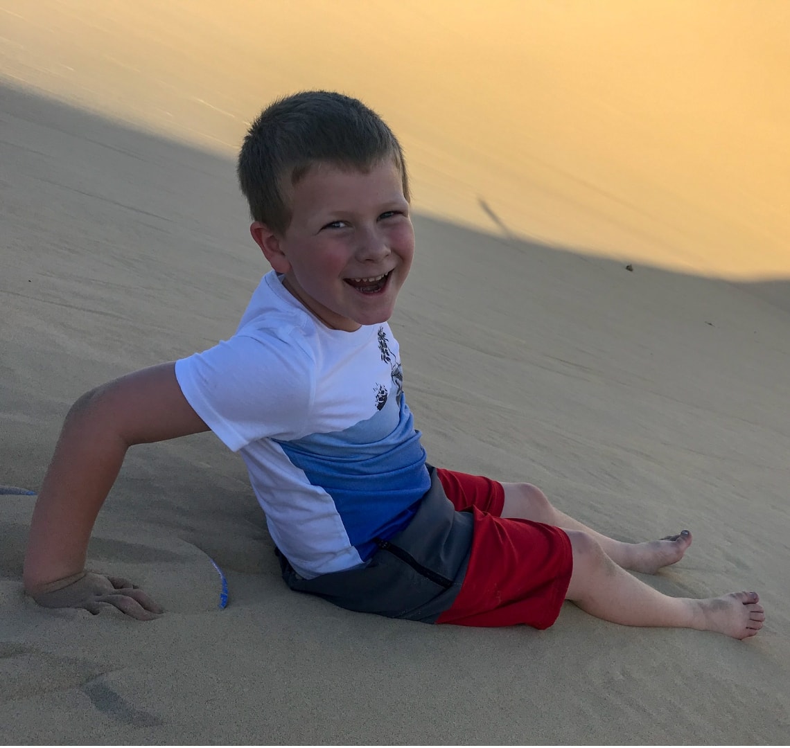 11 incredible things to do in Qatar - Thing 1 sliding down the singing sand dunes
