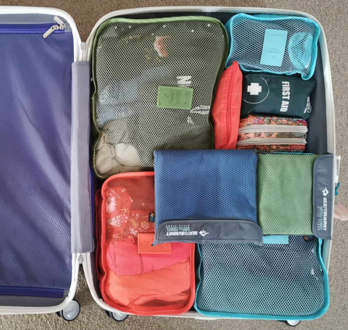 Image of a suitcase packed with packing cubes. 