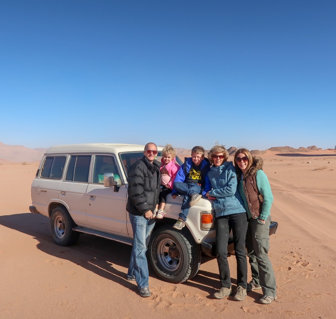 How to have an epic family holiday - Wanderlust family with Granny Wanderlust by our Land Cruiser in Wadi Rum Jordan