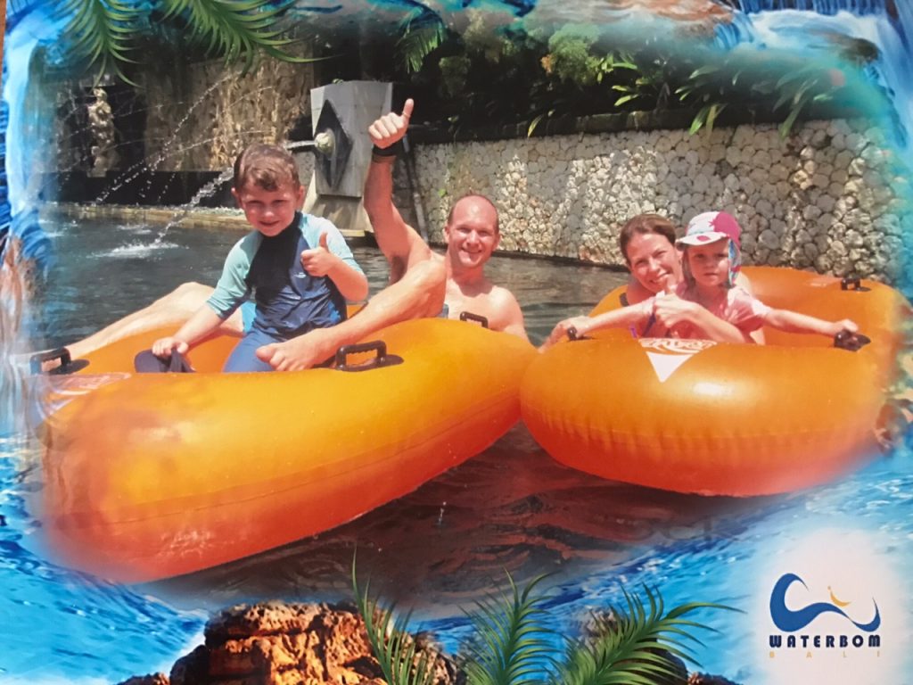 The whole Wanderlust family floating along a lazy river at a water park in Bali -trip of a lifetime