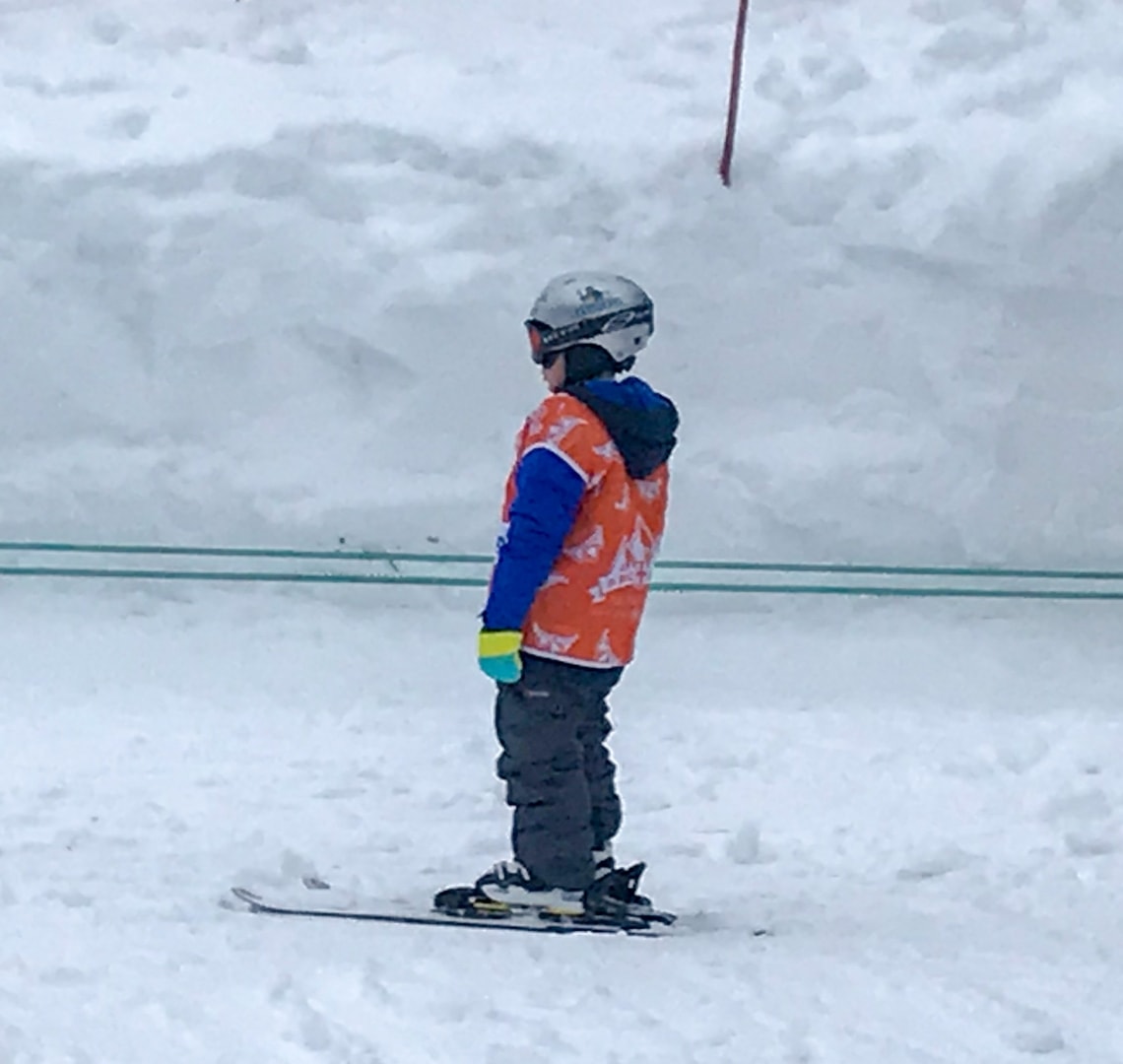 Lessons from travelling with kids - Thing 1 on a ski drag lift