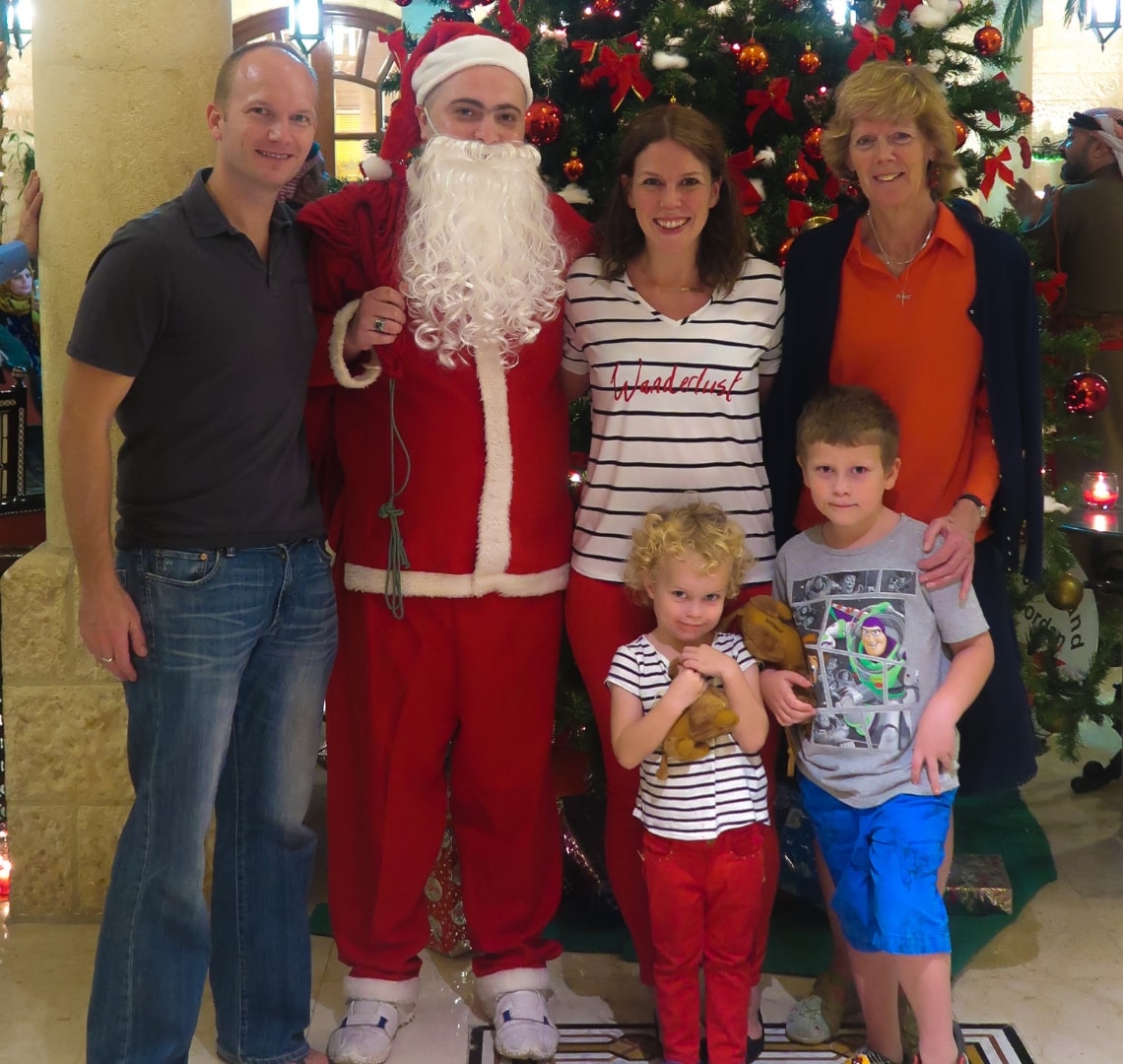 Normal Expat Christmas - Wanderlust family with Father Christmas in front of a Christmas tree