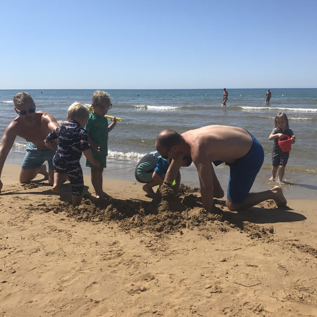 Mr Wanderlust and his friend building sandcastles with some of the Things - trip of a lifetime