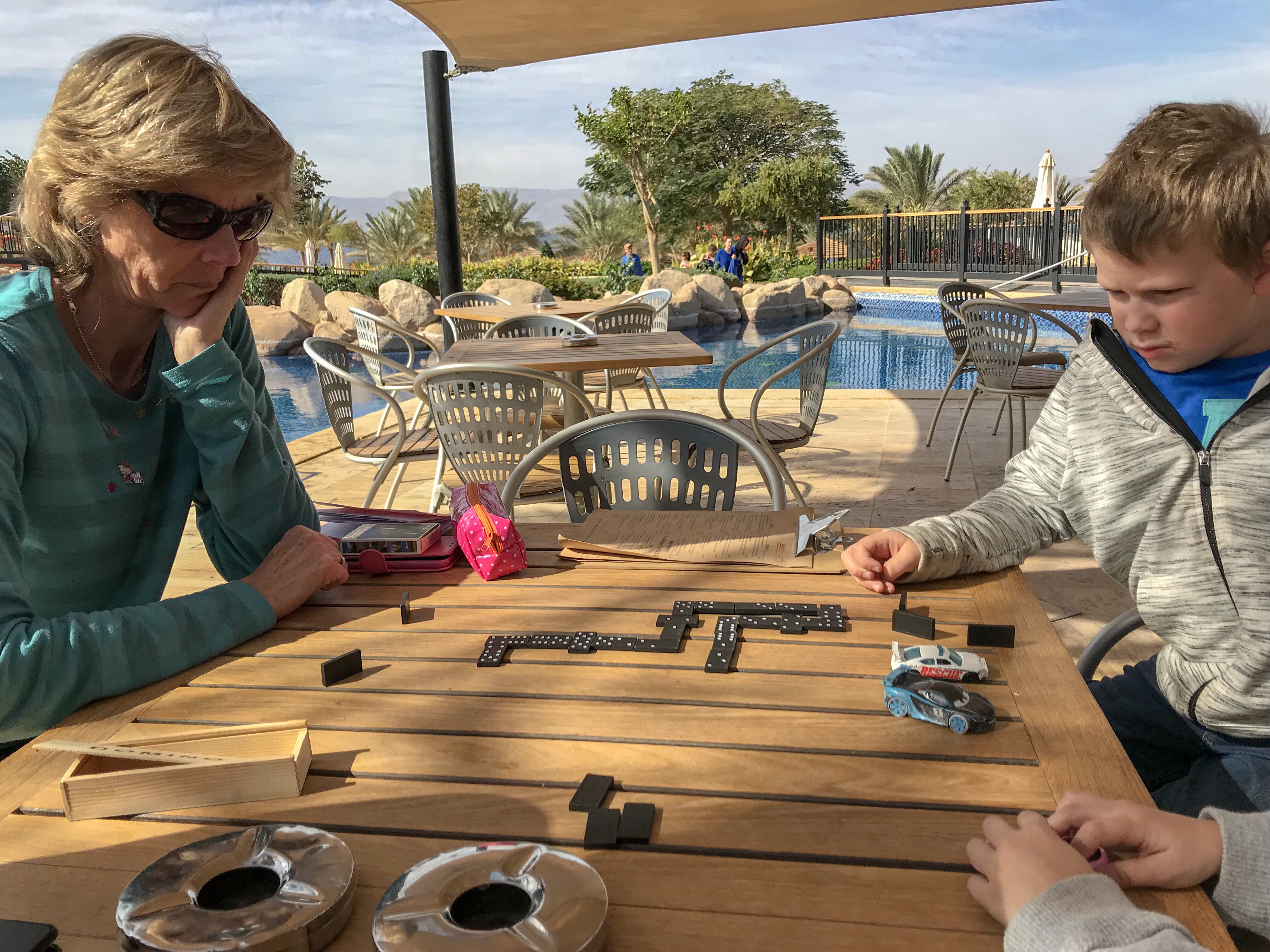 Granny Wanderlust playing dominoes with the Things by the pool in Aqaba